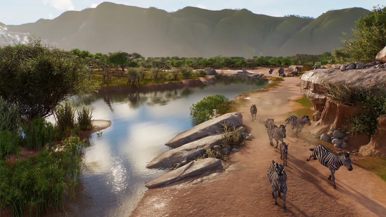 A river and herds of animals in a broad mountainous Wildlife Reserve